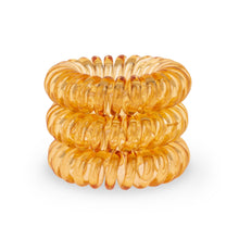 Load image into Gallery viewer, A tower of 3 Tangerine Orange coloured hair bobbles called spirabobbles. A plastic spiral circular hair tie spira bobble.