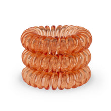 Load image into Gallery viewer, A tower of 3 orange segment coloured hair bobbles called spirabobbles. A plastic spiral circular hair tie spira bobble.
