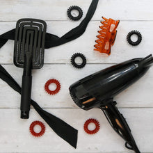 Load image into Gallery viewer, Image showing black hair brush and hair dryer with black hair spirabobbles
