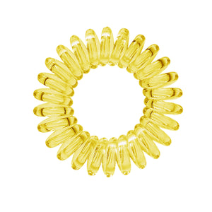 A yellow coloured plastic spiral circular hair bobble on a white background called a spirabobble.