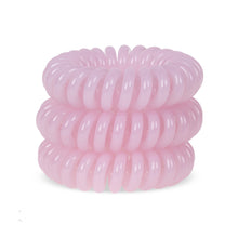 Load image into Gallery viewer, A tower of 3 baby pink coloured hair bobbles called spirabobble. A plastic spiral circular hair tie spira bobble.