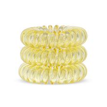 Load image into Gallery viewer, A tower of 3 light yellow coloured hair bobbles called spirabobbles. A yellow plastic spiral circular hair tie spira bobble.
