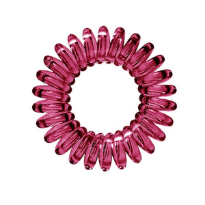 A maroon red coloured plastic spiral circular hair bobble on a white background called a spirabobble.
