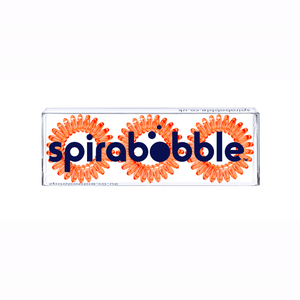 A flat transparent box of 3 orange segment coloured hair accessories called spirabobble