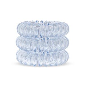 A tower of 3 pale blue coloured hair bobbles called spirabobbles. A plastic spiral circular hair tie spira bobble.