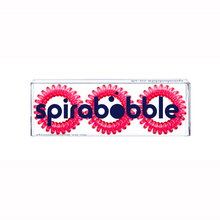 Load image into Gallery viewer, A flat transparent box of 3 perfect rose pink coloured hair accessories called spirabobbles