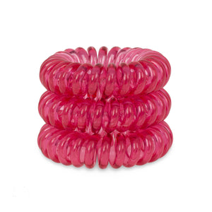 A tower of 3 perfect rose pink coloured hair bobbles called spirabobbles. A plastic spiral circular hair tie spira bobble.