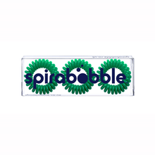 Load image into Gallery viewer, A flat transparent box of 3 green dream coloured hair accessories called spirabobble

