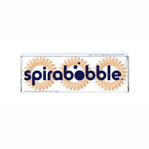A flat transparent box of 3 Perfectly Peach coloured hair accessories called spirabobble