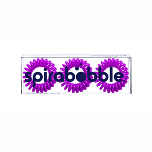 A flat transparent box of 3 purple berry coloured hair accessories called spirabobbles