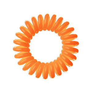 An orange coloured plastic spiral circular hair bobble on a white background called a spirabobble.
