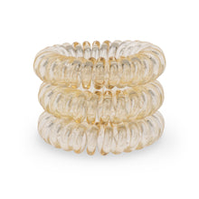 Load image into Gallery viewer, A tower of 3 light orange coloured hair bobbles called spirabobbles. An orange plastic spiral circular hair tie spira bobble.
