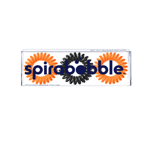 A flat transparent box of 2 orange and one black coloured hair accessories called spirabobbles