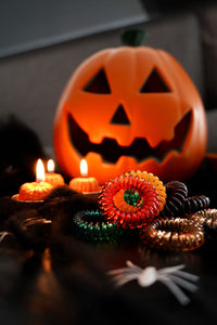 Halloween colours of SpiraBobble Hair Accessories SpiraBobbles with a pumpkin in the background