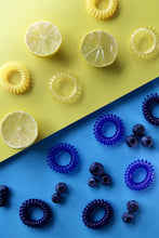 Load image into Gallery viewer, Yellow and blue spirabobbles on matching coloured backgrounds
