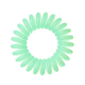 An aqua green coloured plastic spiral circular hair bobble on a white background called a spirabobble