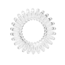 Load image into Gallery viewer, A clear transparent coloured plastic spiral circular hair bobble on a white background called a spirabobble.
