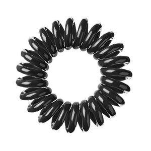 A black coloured plastic spiral circular hair bobble on a white background called a spirabobble.