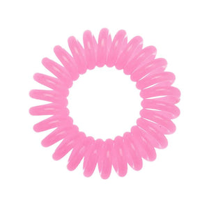 A candy pink coloured plastic spiral circular hair bobble on a white background called a spirabobble.