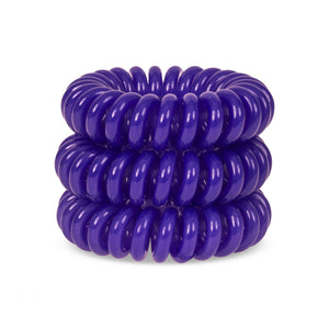 A tower of 3 deep purple coloured hair bobbles called spirabobbles. A purple plastic spiral circular hair tie spira bobble.