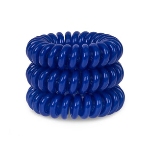 A tower of 3 blue beauty coloured hair bobbles called spirabobble. A blue plastic spiral circular hair tie spira bobble.