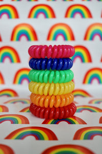A tower of different coloured spirabobbles in the colours of the rainbow