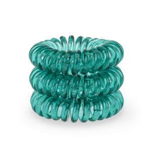 A tower of 3 serene green coloured hair bobbles called spirabobbles. A plastic spiral circular hair tie spira bobble.