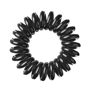 A black magic coloured plastic spiral circular hair bobble on a white background called a spirabobble
