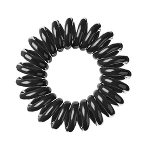 A black magic coloured plastic spiral circular hair bobble on a white background called a spirabobble