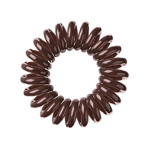 A brown sugar coloured plastic spiral circular hair bobble on a white background called a spirabobble.