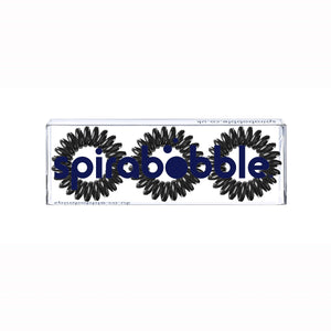 A flat transparent box of 3 black magic coloured hair accessories called spirabobbles
