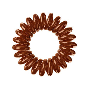 A cinnamon bun brown coloured plastic spiral circular hair bobble on a white background called a spirabobble.