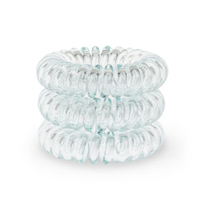 A tower of 3 clear aqua green coloured hair bobbles called spirabobble. A plastic spiral circular hair tie spira bobble.