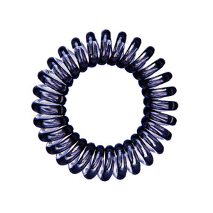 A black coloured plastic spiral circular hair bobble on a white background called a spirabobble.