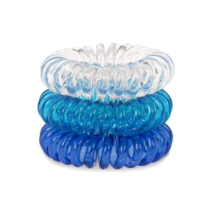 A tower of 3 different coloured hair bobbles called Blue Heaven spirabobbles. A plastic spiral circular hair tie spira bobble.