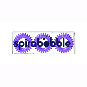 A flat transparent box of 3 purple coloured hair accessories called spirabobbles