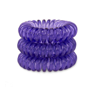 A tower of 3 deep purple coloured hair bobbles called spirabobbles. A purple plastic spiral circular hair tie spira bobble