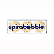 Load image into Gallery viewer, A flat transparent box of 3 light orange coloured hair accessories called spirabobbles
