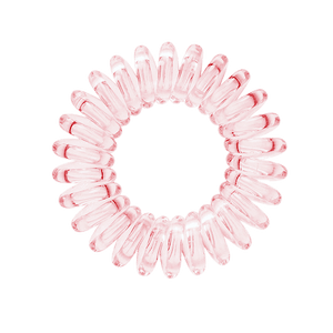 A light pink spiral hair bobble in light pink on a white background
