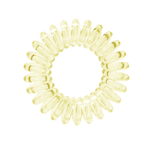 Load image into Gallery viewer, A light yellow coloured plastic spiral circular hair bobble on a white background called a spirabobble.
