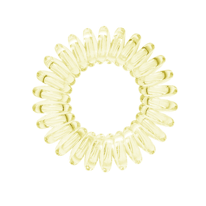 A light yellow coloured plastic spiral circular hair bobble on a white background called a spirabobble.