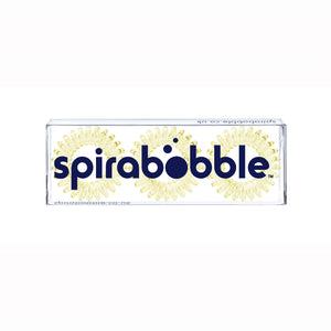 A flat transparent box of 3 light yellow coloured hair accessories called spirabobbles