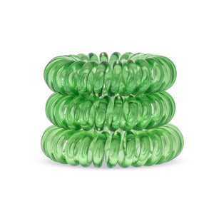 A tower of 3 lime time green coloured hair bobbles called spirabobbles. A green plastic spiral circular hair tie spira bobble.