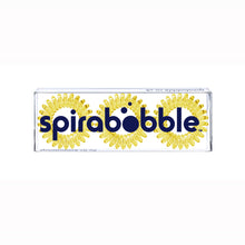 Load image into Gallery viewer, A flat transparent box of 3 mellow yellow coloured hair accessories called spirabobbles
