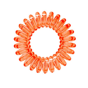 A orange segment coloured plastic spiral circular hair bobble on a white background called a spirabobble.