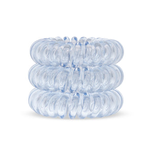 A tower of 3 pale blue coloured hair bobbles called spirabobbles. A plastic spiral circular hair tie spira bobble.