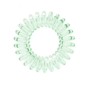 A pale green coloured plastic spiral circular hair bobble on a white background called a spirabobble.