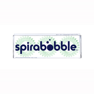 A flat transparent box of 3 pale green coloured hair accessories called spirabobbles