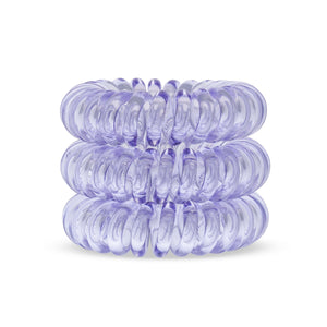A tower of 3 pale purple coloured hair bobbles called spirabobbles. A plastic spiral circular hair tie spira bobble.