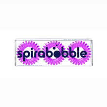Load image into Gallery viewer, A flat transparent box of 3 purple berry coloured hair accessories called spirabobbles
